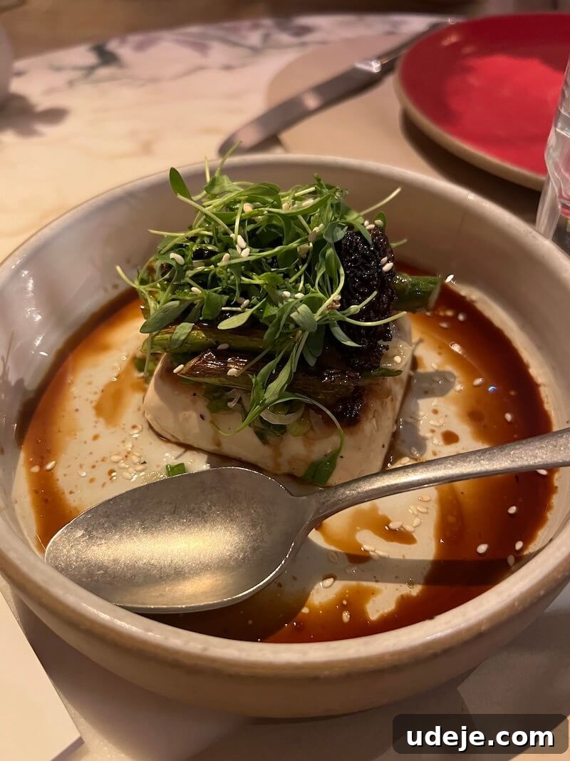 The Ultimate New York City Vegan Restaurant and Cafe Guide 13 Plate of seared tofu garnished with fresh herbs and served with a side of vegetables at abcV in New York City.