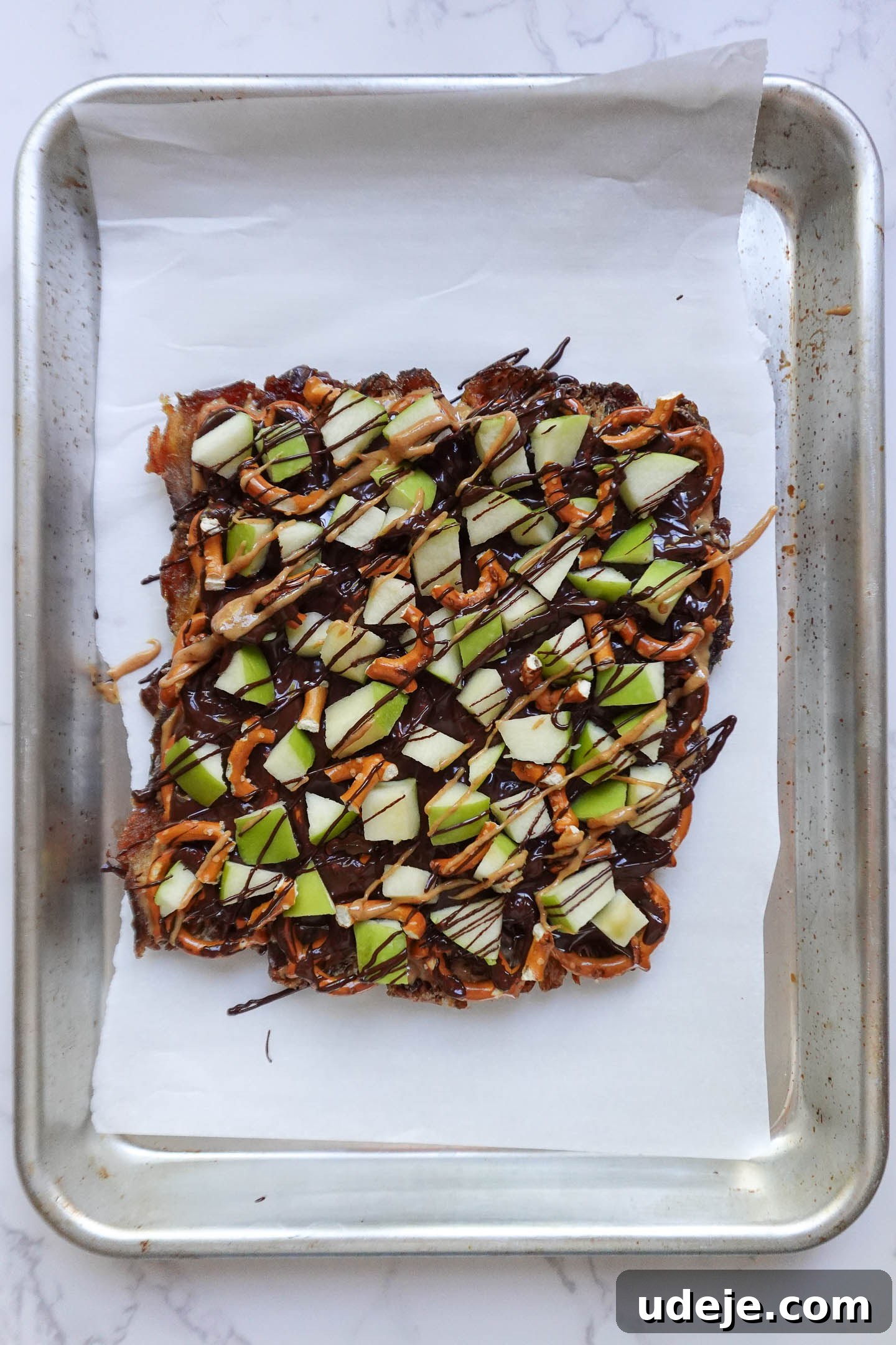 Wholesome Apple Date Caramel Bark 7 Drizzling melted vegan chocolate and nut butter over caramel apple date bark before freezing