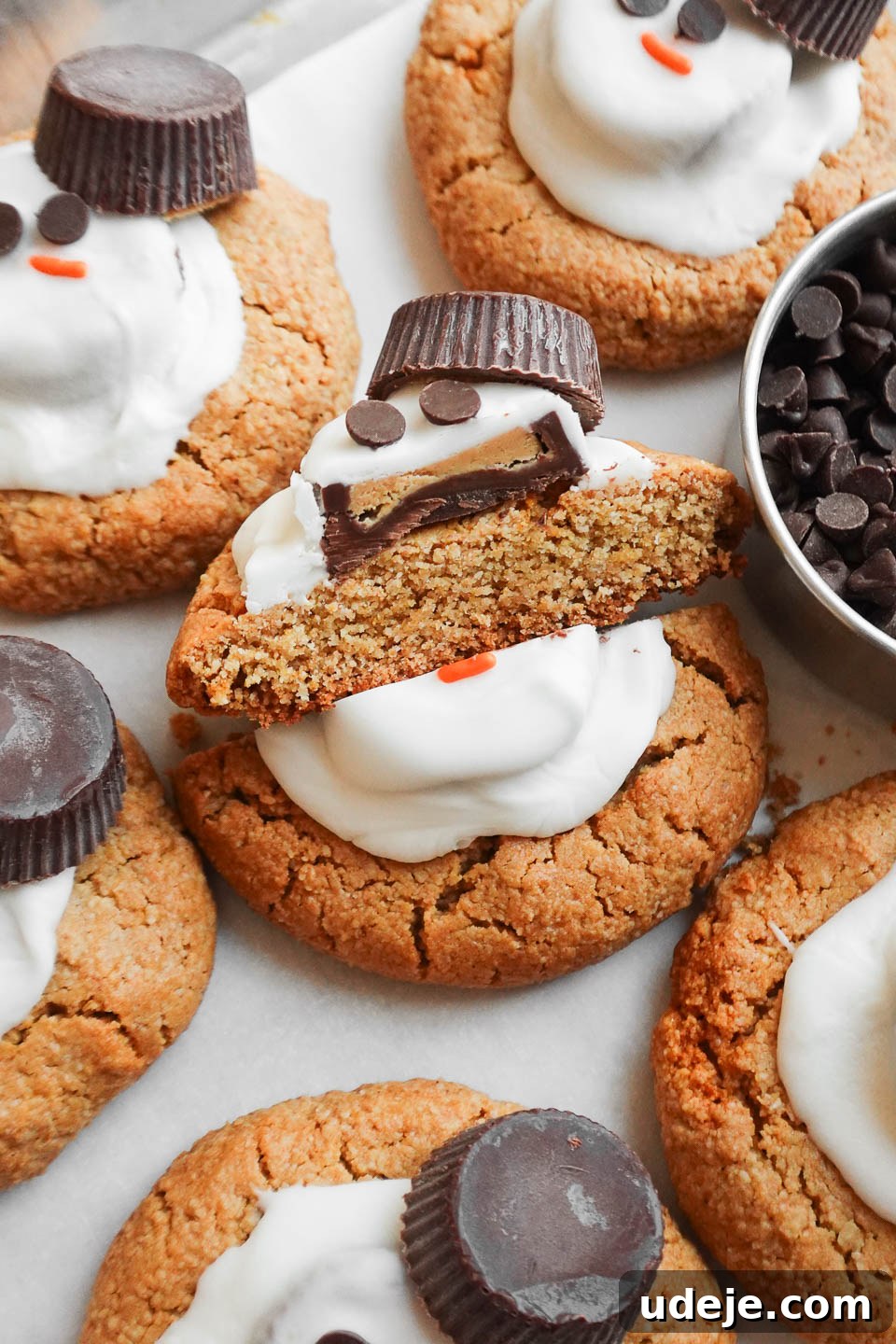 Whimsical Vegan Gluten Free Melted Snowman Cookies 3 Close-up of a vegan melted snowman cookie cut in half, revealing the soft, chewy peanut butter cookie interior and the melted white chocolate topping.