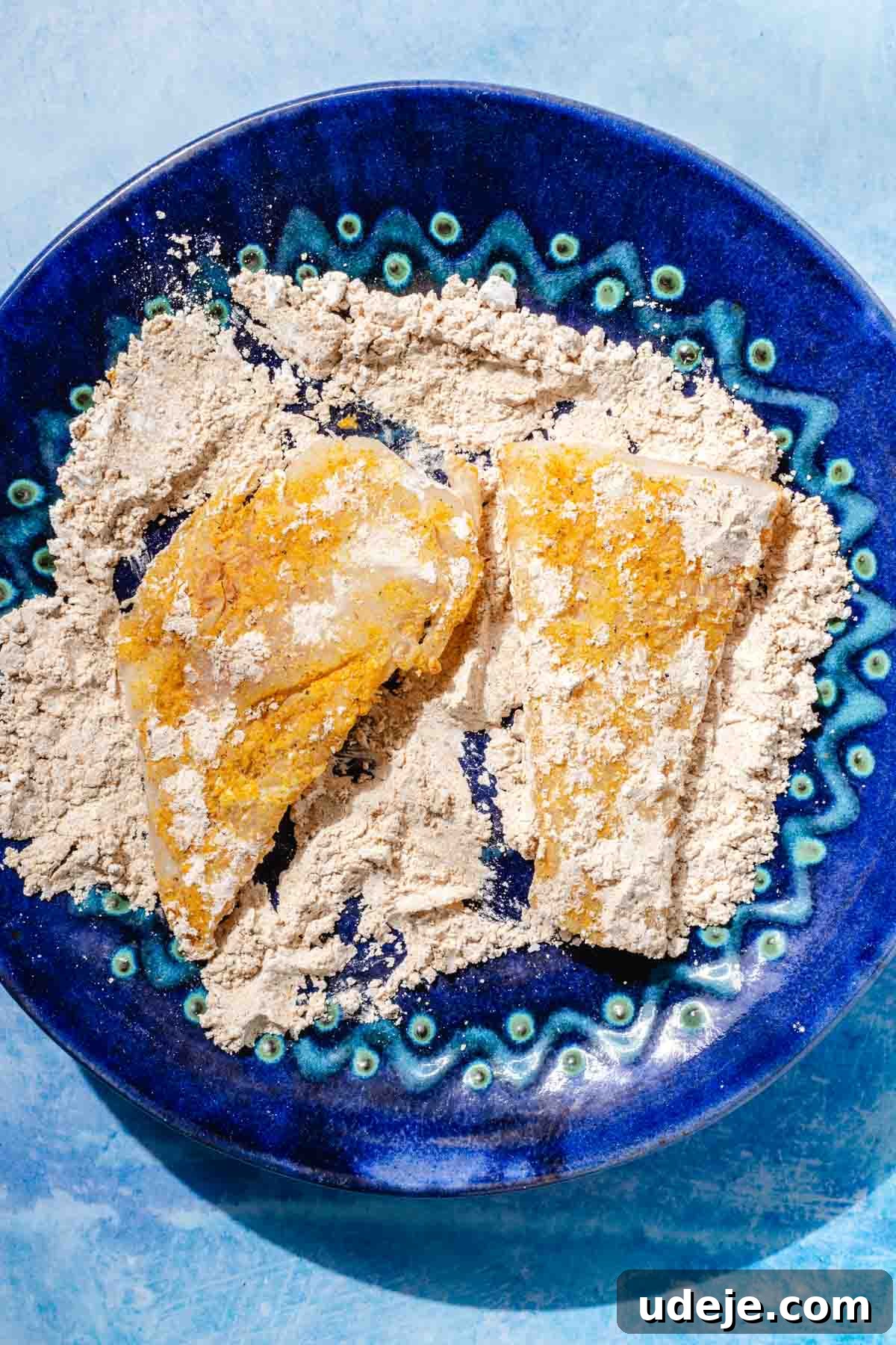 Fragrant Middle Eastern Fish Pilaf 12 Cod fillets in a spiced cornstarch mix on a blue patterned plate