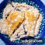 Fragrant Middle Eastern Fish Pilaf 25 Cod fillets in a spiced cornstarch mix on a blue patterned plate