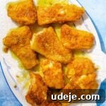 Fragrant Middle Eastern Fish Pilaf 26 Fried cod fillets on paper towels on a white and blue patterned platter on a blue background