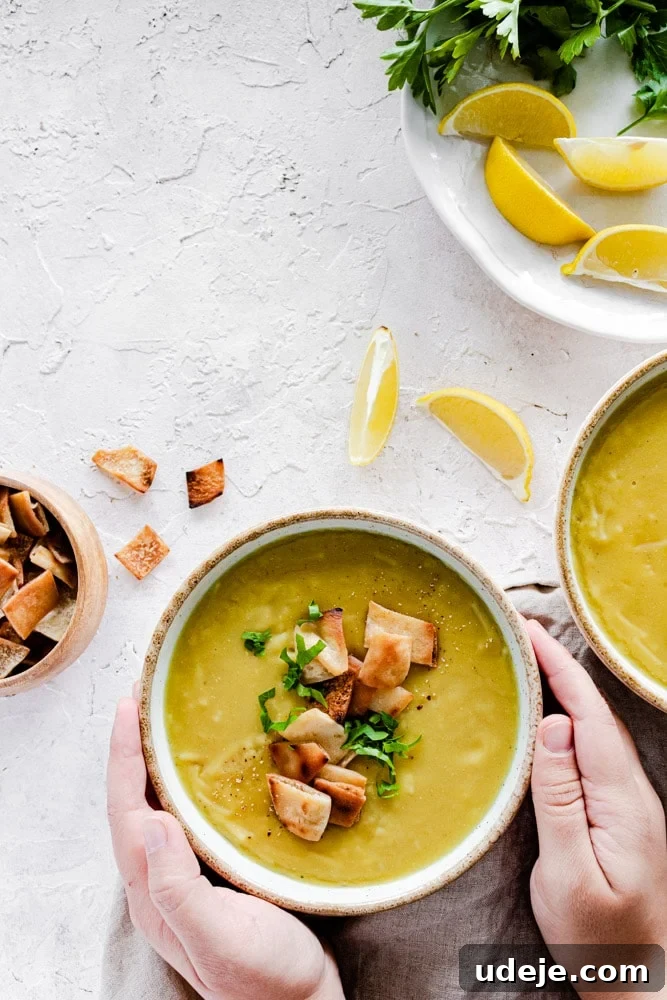 Middle Eastern Lentil Soup Two Ways 7 Arabic Lentil Soup elegantly served in individual bowls, topped with crispy golden pita chips and a sprinkle of fresh parsley, awaiting enjoyment.