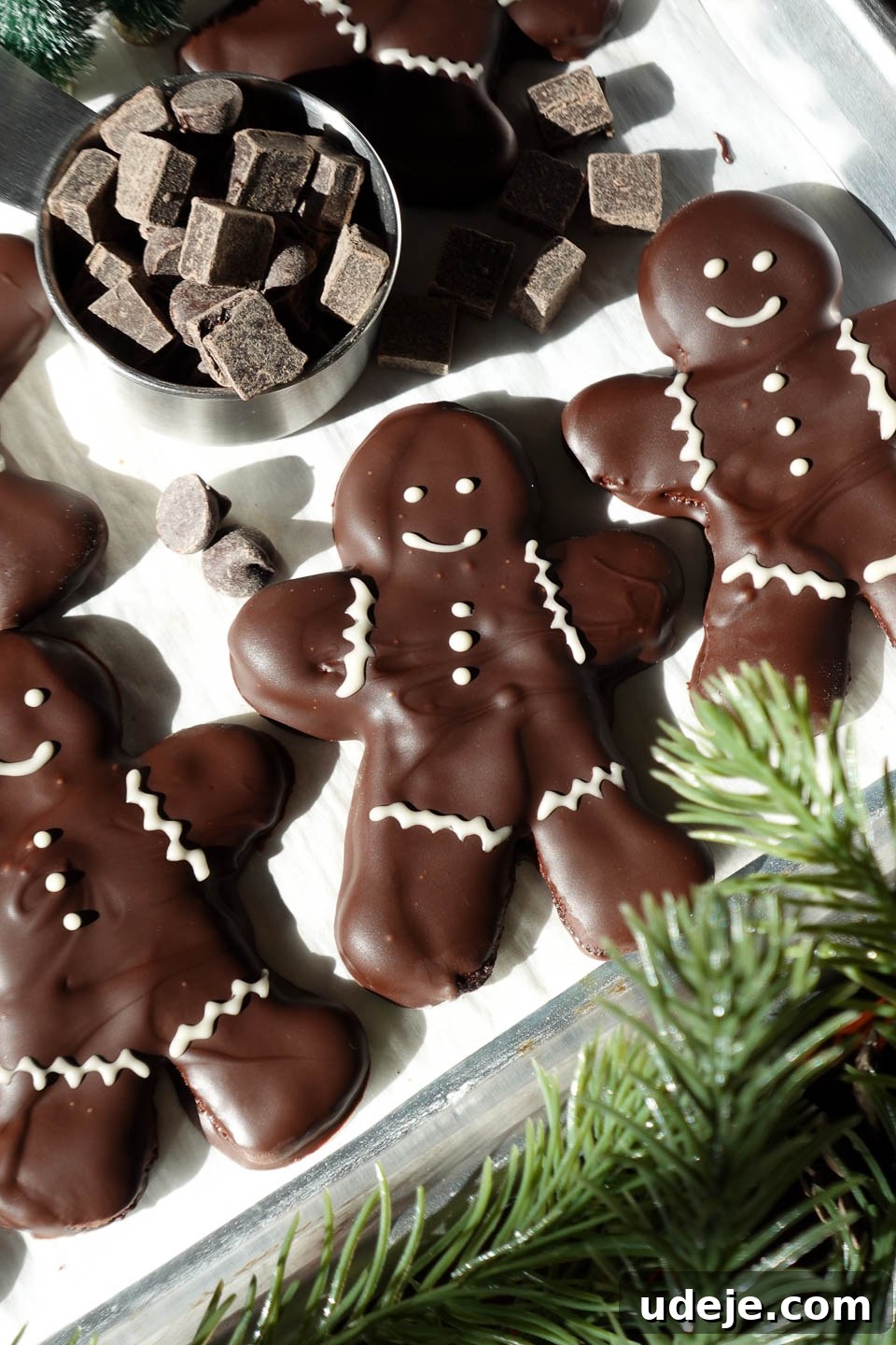 Decadent Vegan Gluten-Free Peppermint Chocolate Delights 2 Vegan chocolate peppermint cookies decorated like gingerbread men with white chocolate faces and buttons