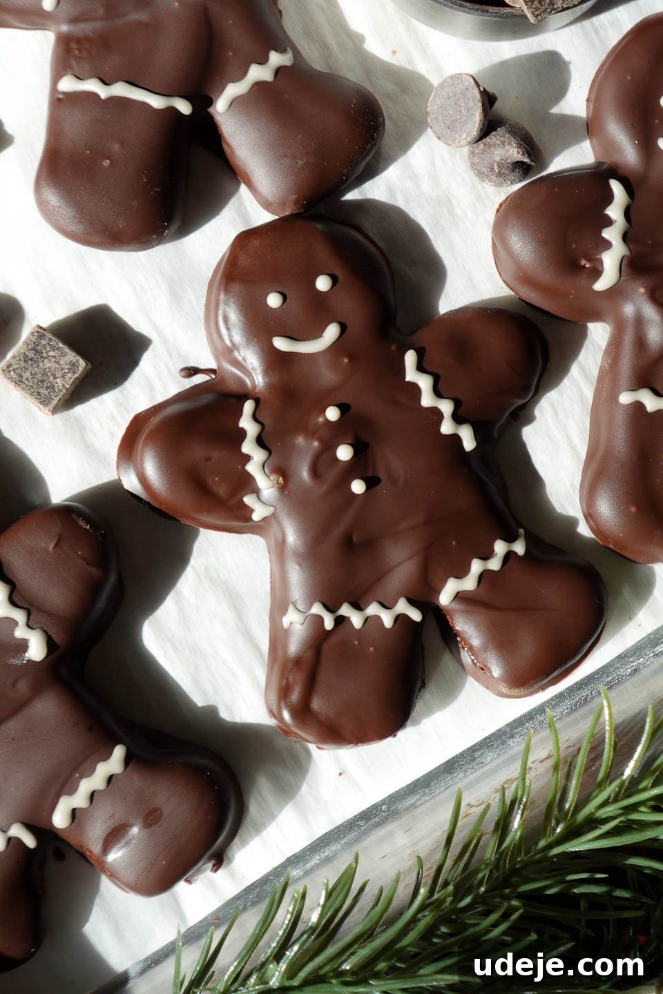Decadent Vegan Gluten-Free Peppermint Chocolate Delights 5 Close-up of vegan chocolate peppermint gingerbread men cookies dipped in melted chocolate and decorated with white chocolate details