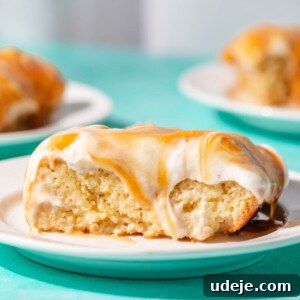 Close up of Turkish tres leches slice on a white plate on a blue background