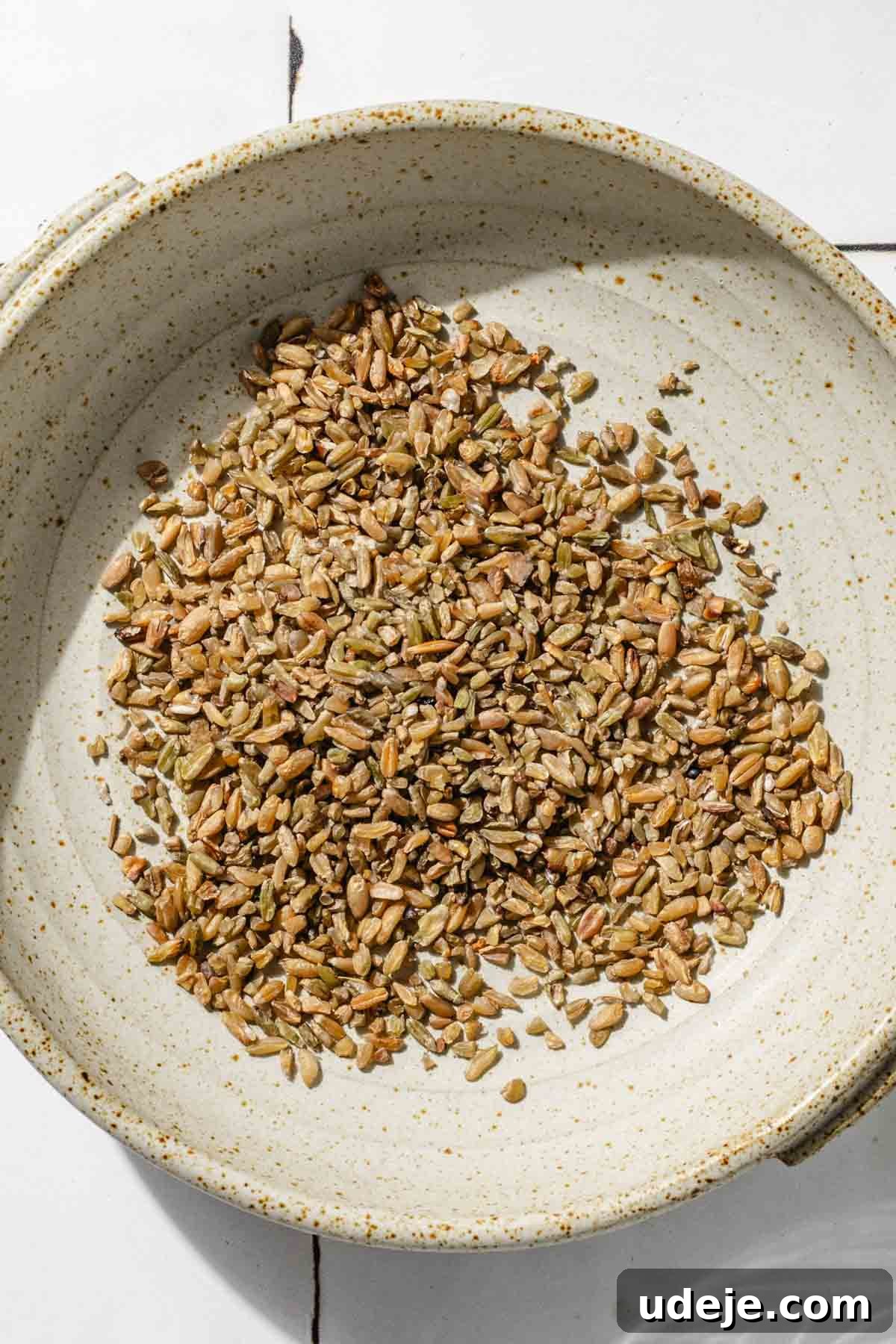 Silky Freekeh Bean Fiesta 3 Uncooked freekeh grains in a small beige bowl