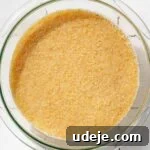 Bulgur in a glass bowl on a white tiled surface