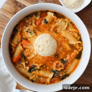 Vegan lasagna soup with a creamy tofu ricotta topping on a cutting board