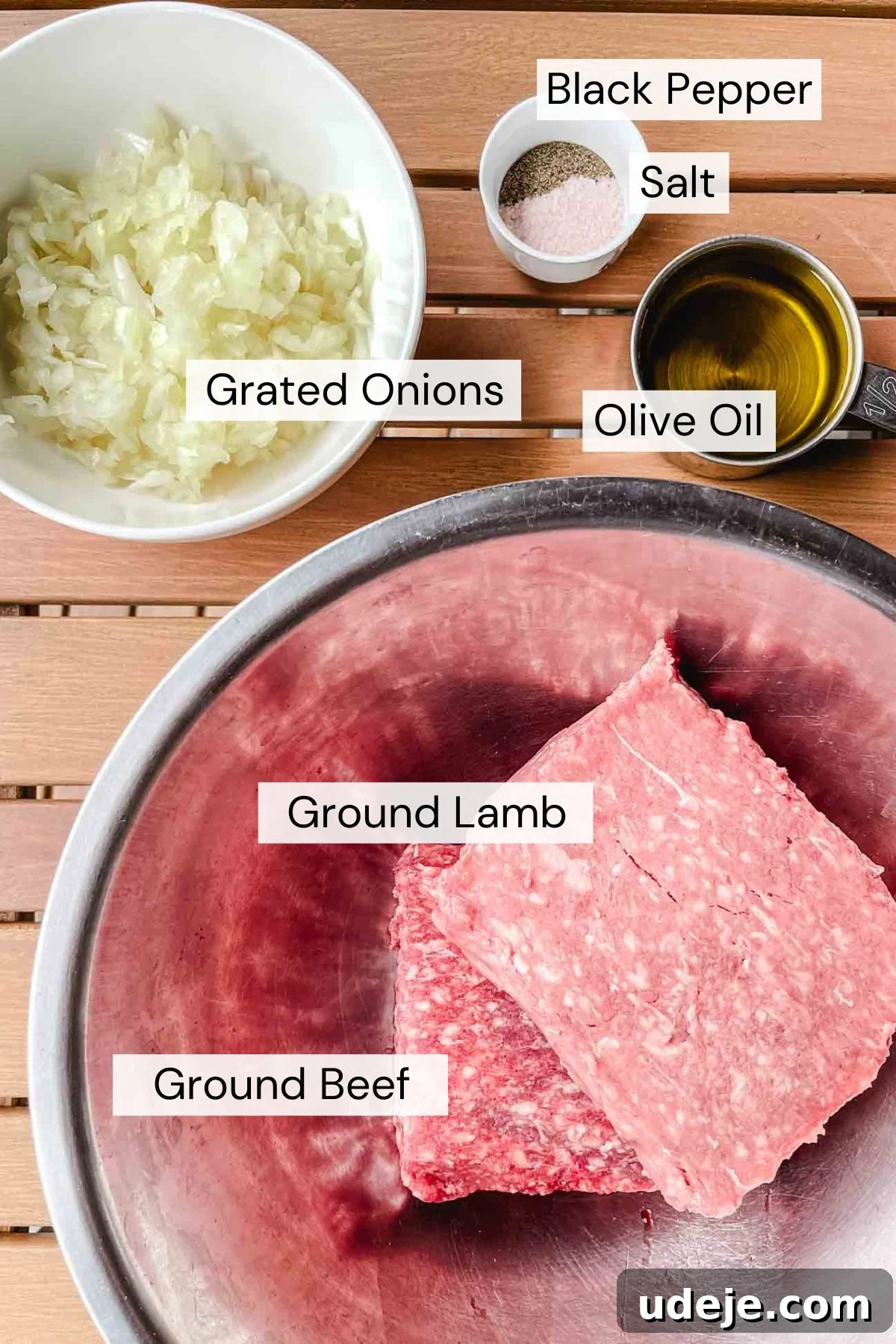 Sizzling Iraqi Kabab A Taste of Tradition 4 Ingredients for Iraqi kabab which include ground beef, ground lamb, grated onions, salt, pepper, and olive oil, arranged neatly on a wooden surface.
