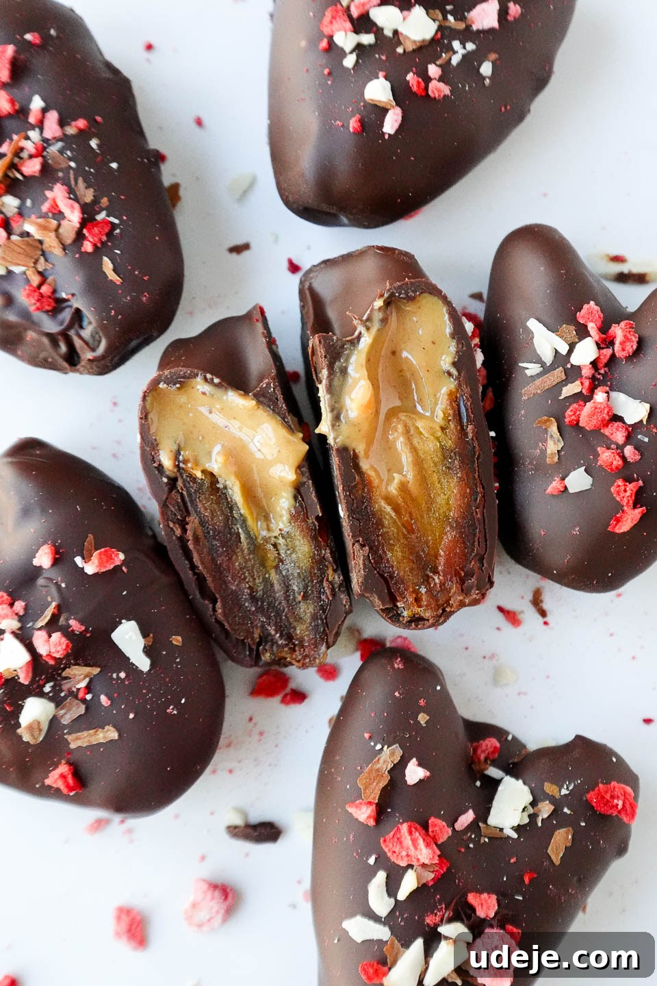 Decadent Chocolate Date Gems 3 Close up of a Medjool date heart, sliced in half to reveal the rich peanut butter filling, perfect for a Valentine's Day treat.