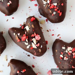 Decadent Chocolate Date Gems 5 Close-up of heart-shaped Medjool dates stuffed with peanut butter and coated in dark chocolate - a healthy valentine's day dessert!