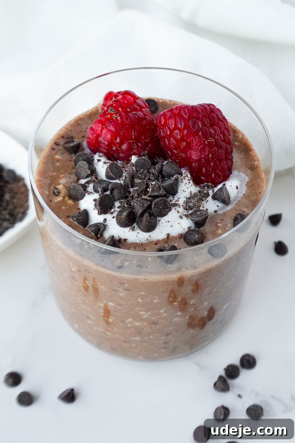 Fudgy Brownie Overnight Oats 4 Decadent Brownie Batter Overnight Oats topped with vegan yogurt, chocolate chips and fresh raspberries, a perfect balance of indulgence and health.