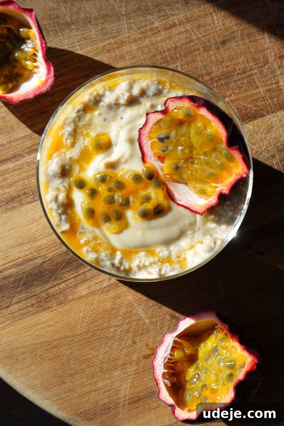 Tropical Mango Passion Overnight Oats 4 Vibrant Mango & Passion Fruit Overnight Oats in a glass jar, topped with a fresh passionfruit half and diced mango, ready to be enjoyed as a healthy breakfast.