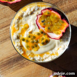 Overhead photo of tropical Mango & Passion Fruit Overnight Oats topped with a halved passionfruit