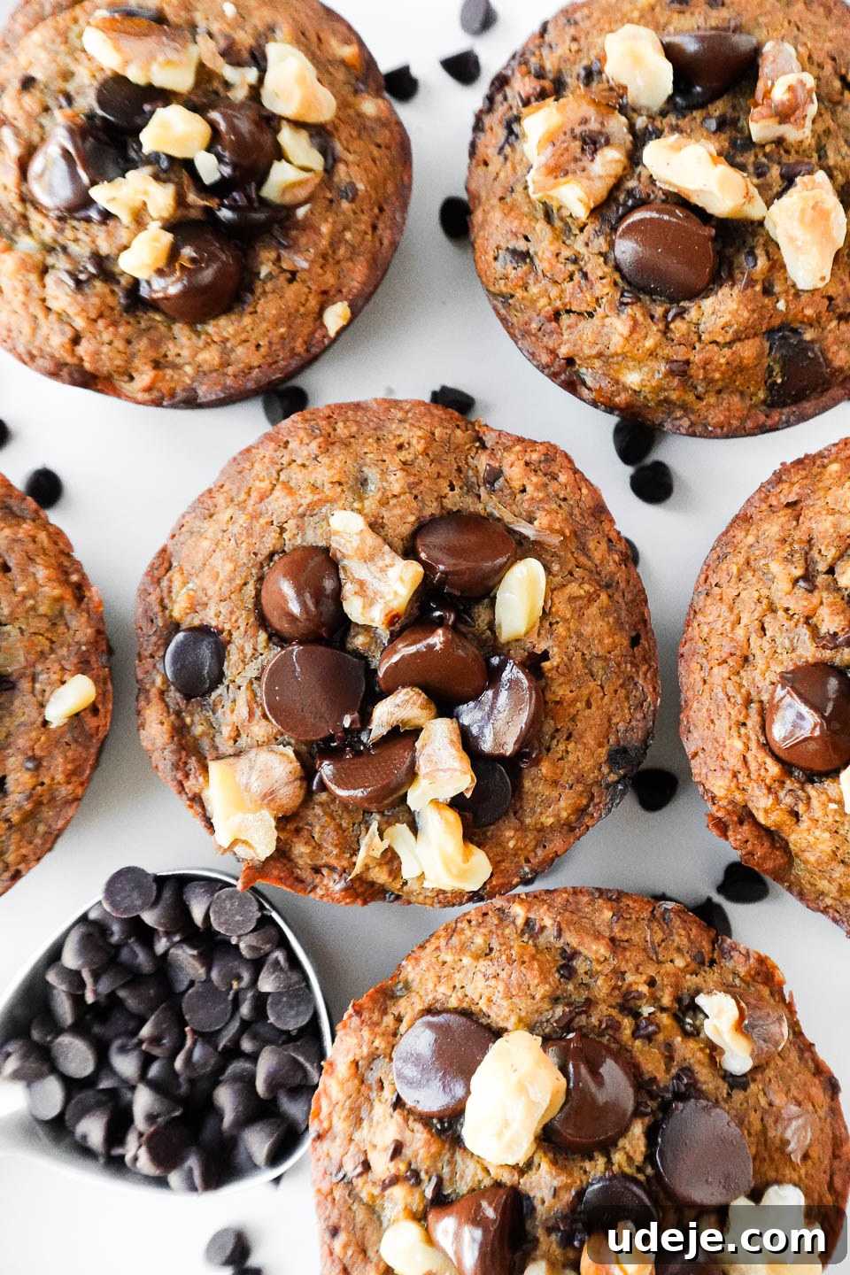 Deliciously Wholesome Vegan Gluten-Free Banana Muffins 3 overhead shot of healthy banana muffins topped with chocolate chips and walnuts, vegan, gluten-free and naturally sweetened.