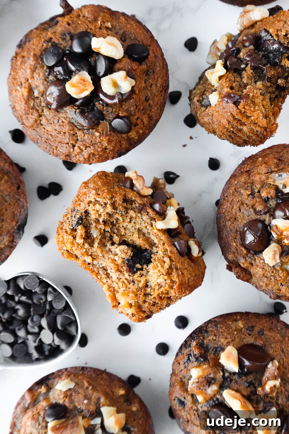 Deliciously Wholesome Vegan Gluten-Free Banana Muffins 5 overhead shot of healthy banana muffins with a bite taken out showing it's fluffy texture