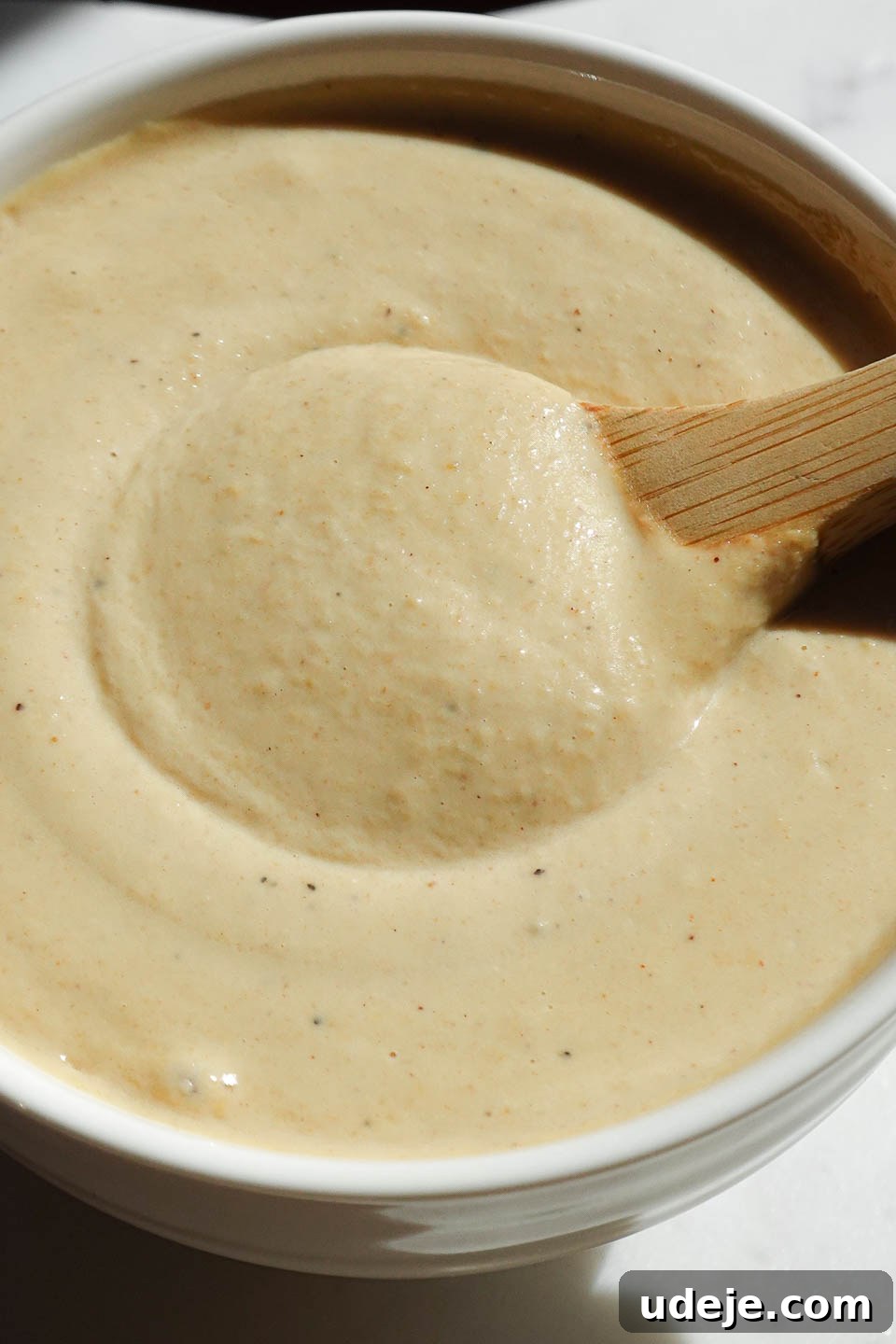 Bright Lemon Tahini Dressing 3 Close-up of Lemon Tahini Dressing made with tahini, lemon juice, and nutritional yeast, showing its smooth texture.