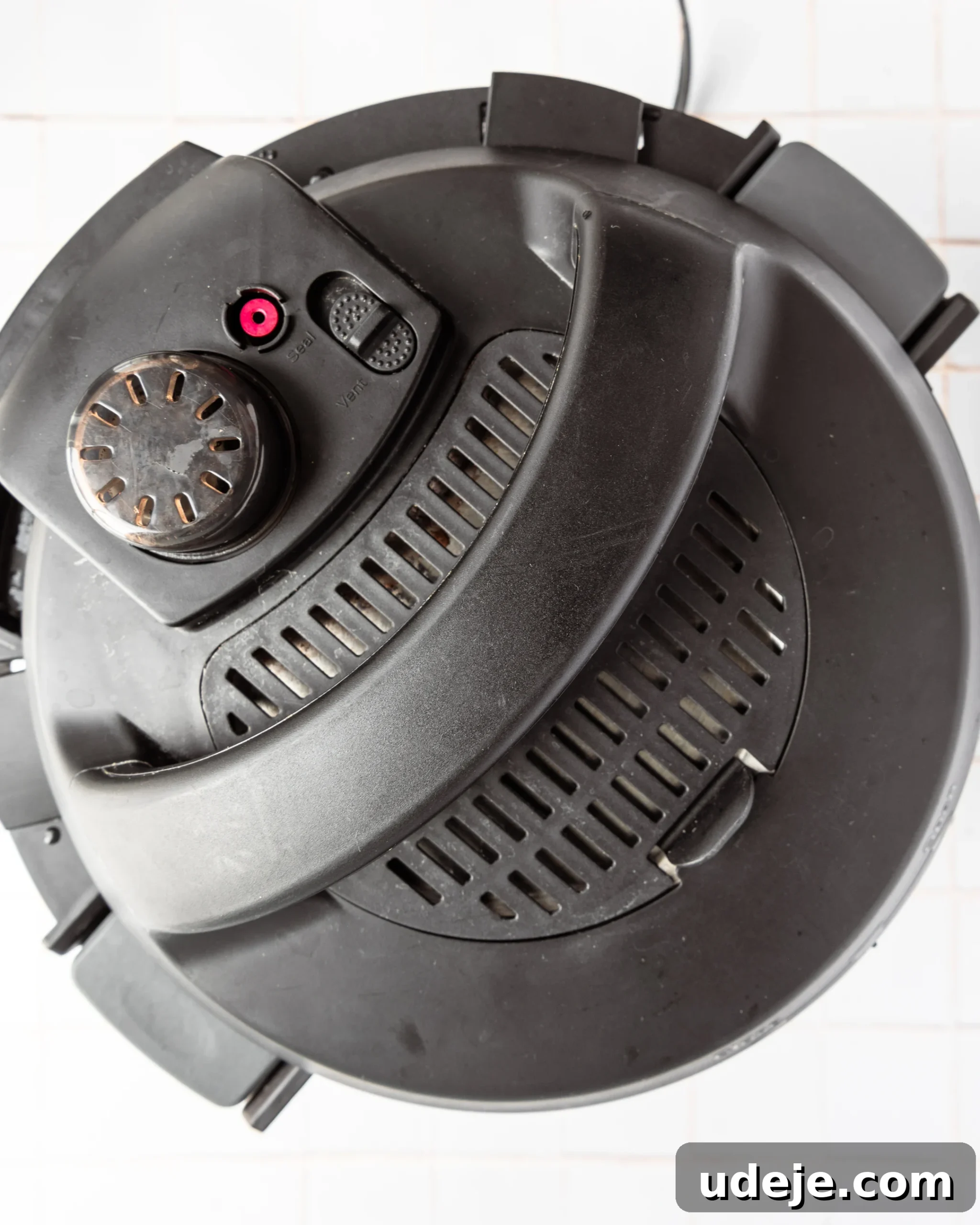 Instant Pot Basmati: Fluffy Perfection in 15 Minutes 9 Closed Instant Pot with the lid sealed, ready for pressure cooking basmati rice, placed on a white tiled background. The sealing valve is set for proper cooking.
