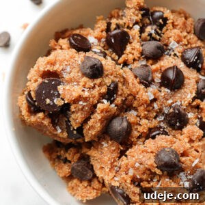 Close-up of vegan and gluten-free edible cookie dough topped with dark chocolate chips and flaky sea salt