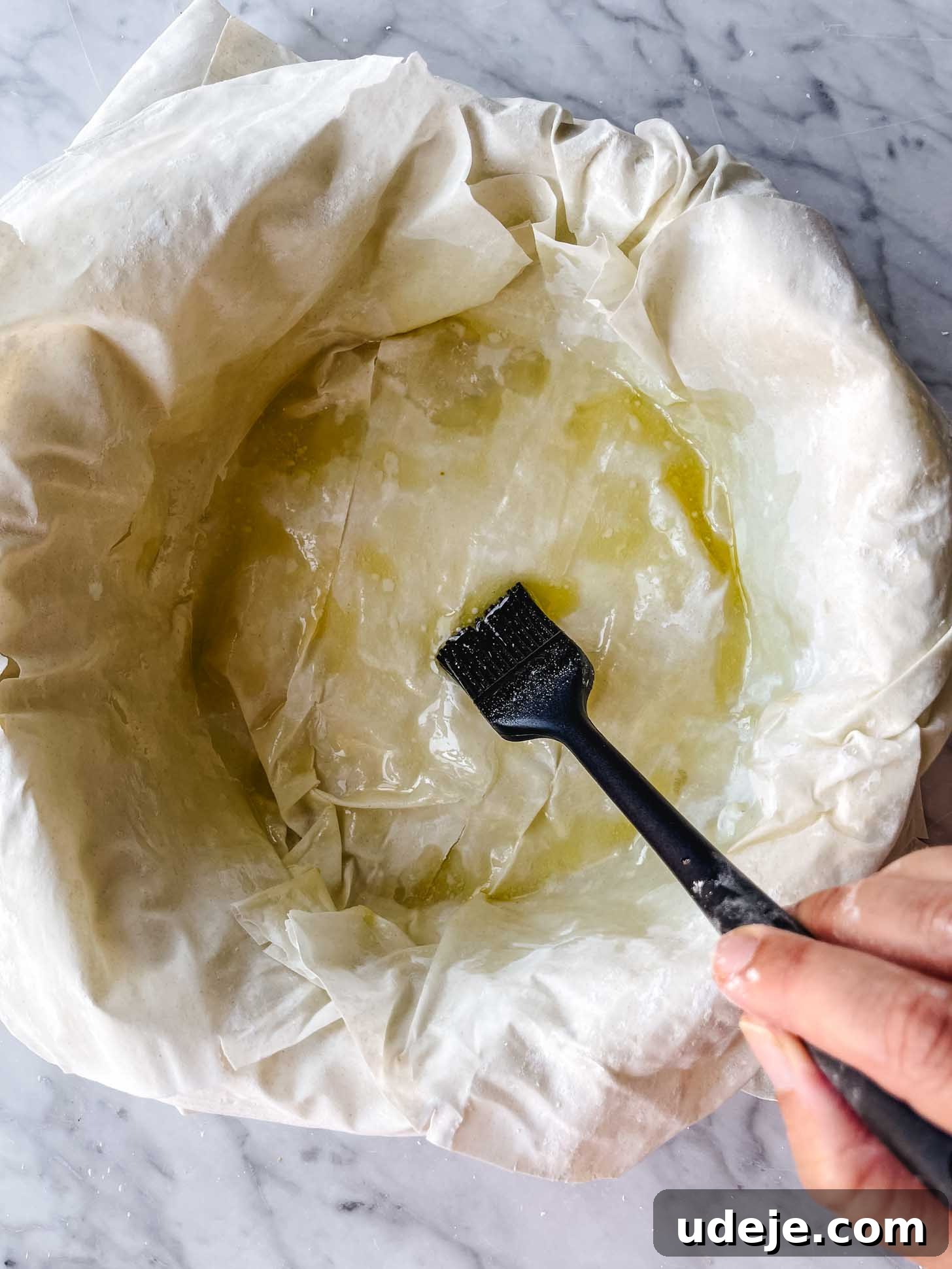 Apple Pie Meets Baklava 12 The last layers of phyllo pastry in the pan being generously brushed with butter.