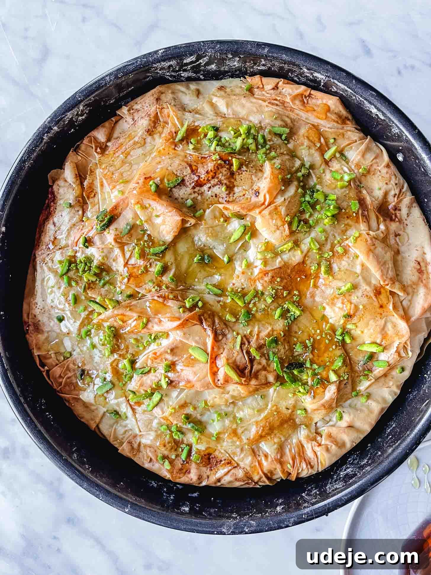 Apple Pie Meets Baklava 17 The top of the Baklava Apple Pie, made with crinkled phyllo and garnished with chopped pistachios, ready for baking.