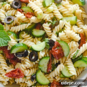 Vegan Mediterranean pasta salad in a bowl, showcasing its colorful ingredients.