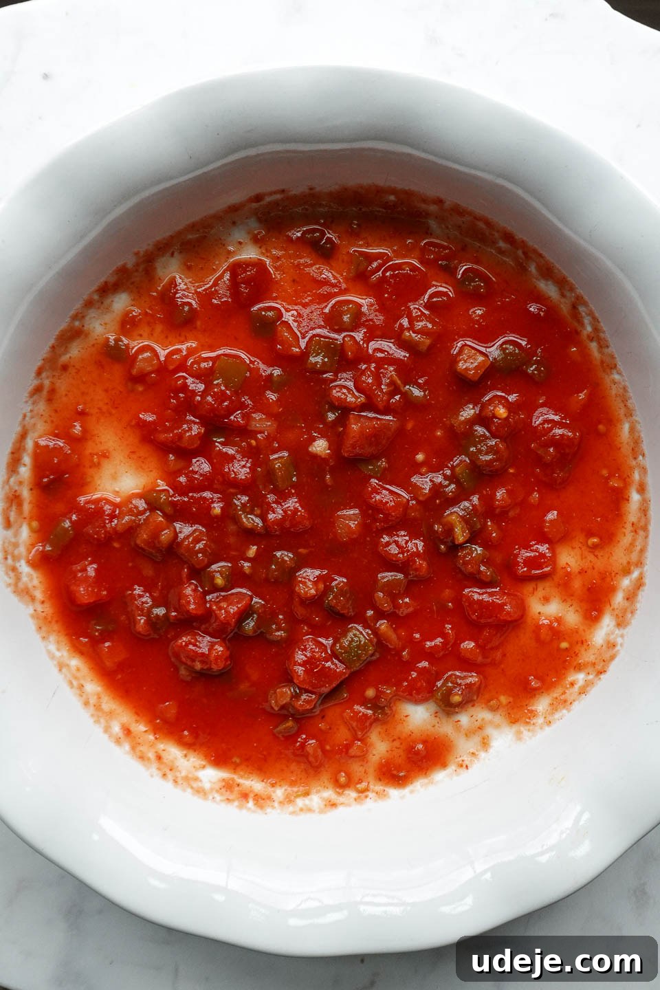 Plant Based Mexican Rice Bake 4 Salsa spread on the bottom of a casserole dish as the first layer