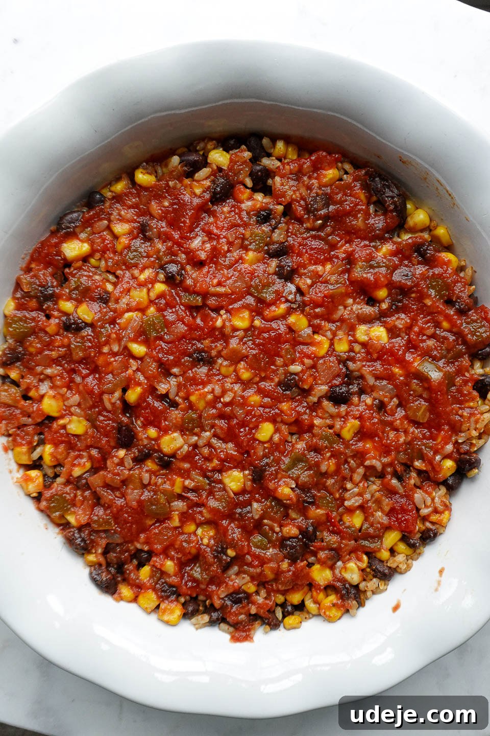 Plant Based Mexican Rice Bake 6 Second layer of salsa spooned over the rice and beans