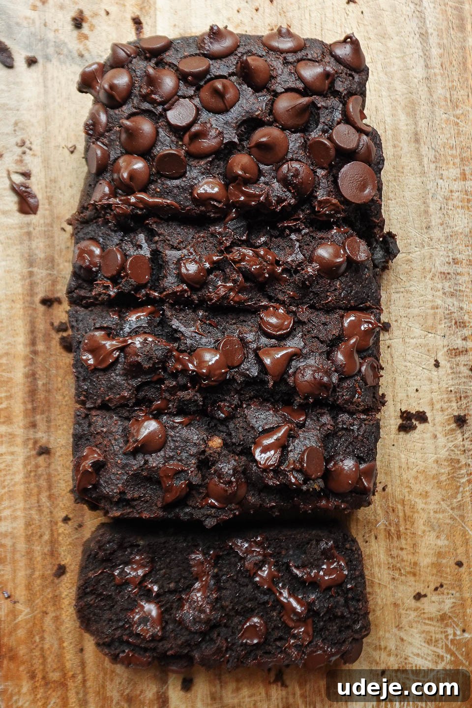 Wholesome Vegan Gluten-Free Chocolate Banana Bread 4 Overhead view of a perfectly sliced healthy chocolate banana bread, revealing a moist and fluffy interior with abundant melty chocolate chips.