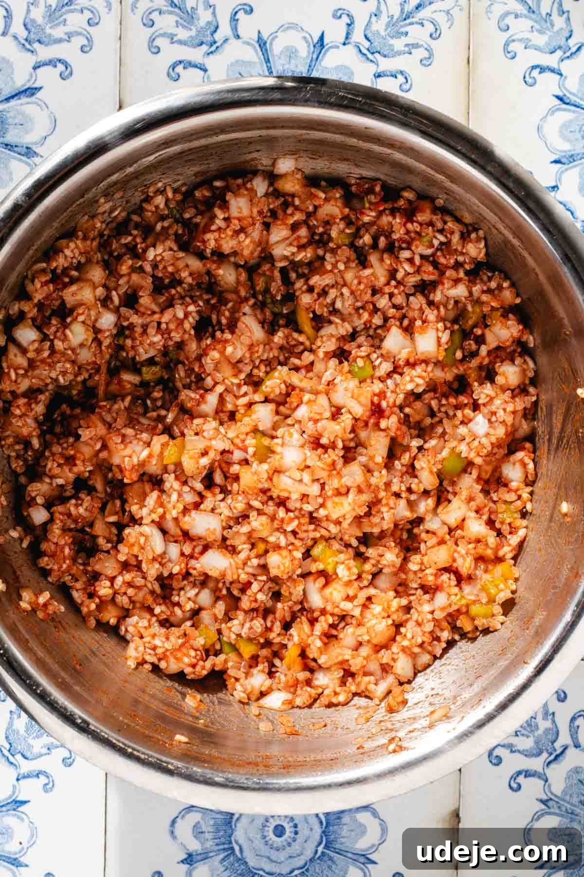 Mediterranean Veggie Stuffed Peppers 6 A raw rice stuffing which includes rice, chopped onions and peppers, tomato paste and spices, in a large stainless steel bowl