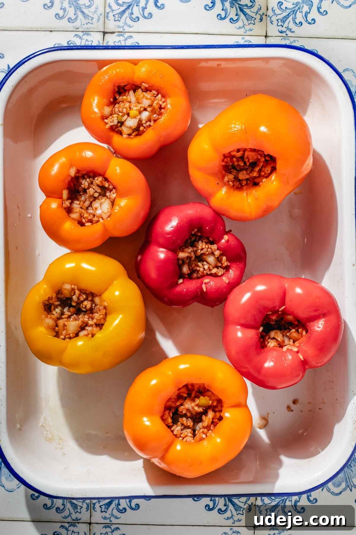 Mediterranean Veggie Stuffed Peppers 8 Large yellow, orange and red bell peppers, hollowed out and stuffed with a rice mixture, placed in a large enamel baking dish