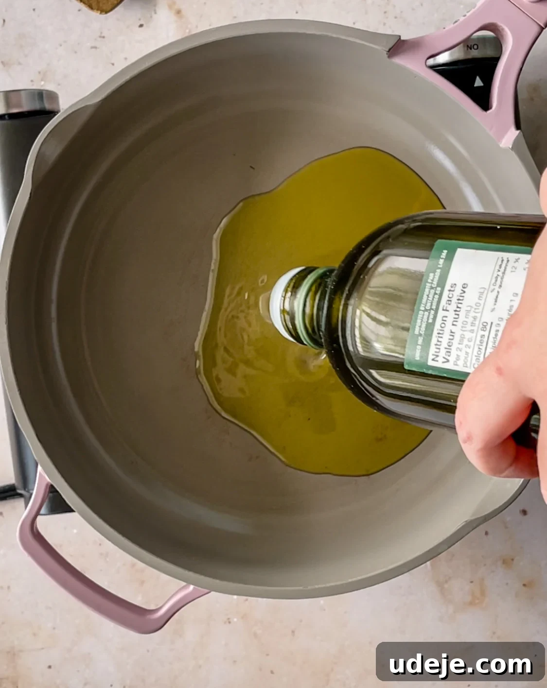 Spicy Golden Crispy Batata Harra 4 Olive oil being poured into a medium skillet