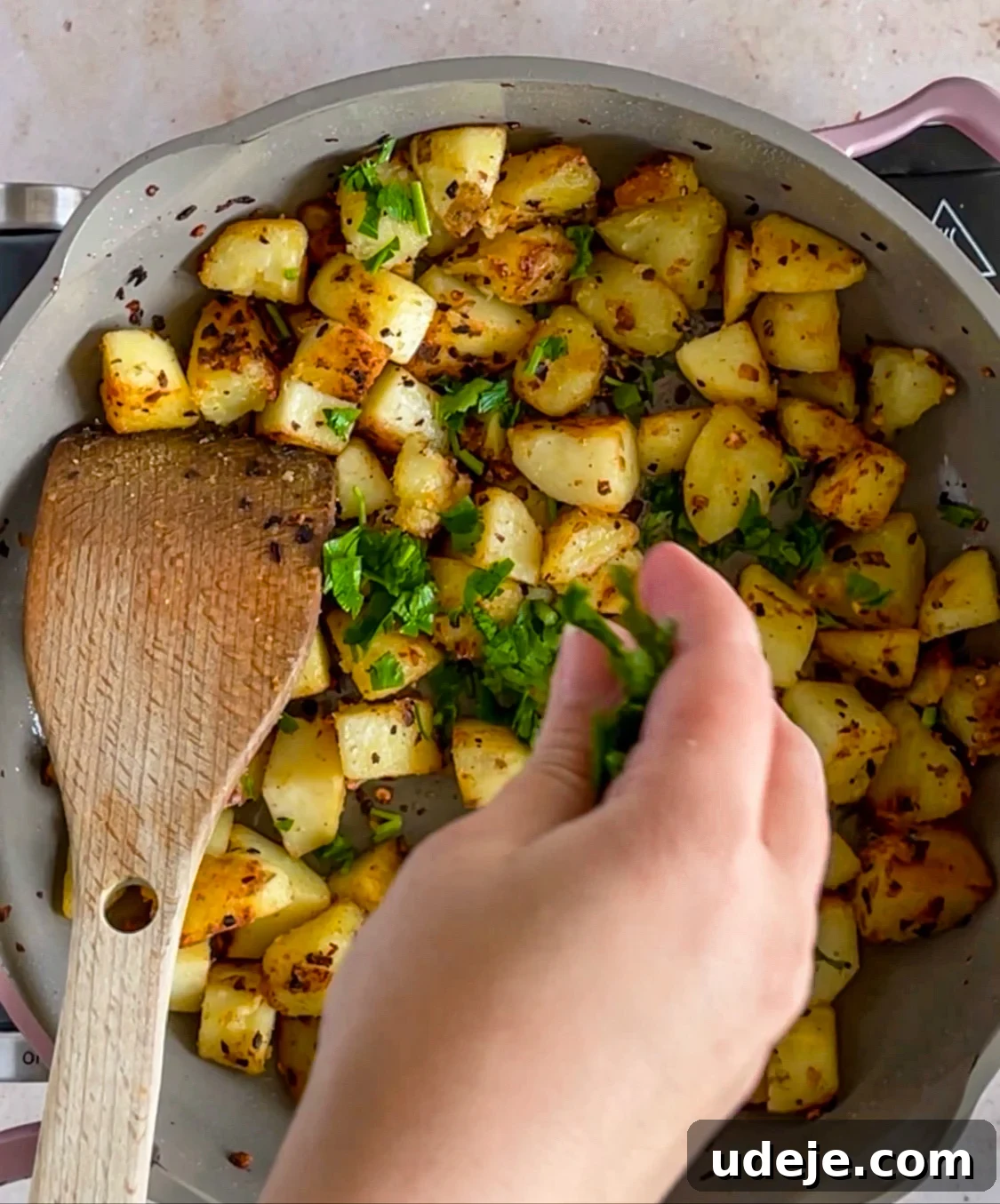 Spicy Golden Crispy Batata Harra 7 Potatoes being cooked and crisped up in a skillet, and being garnished with chopped parsley