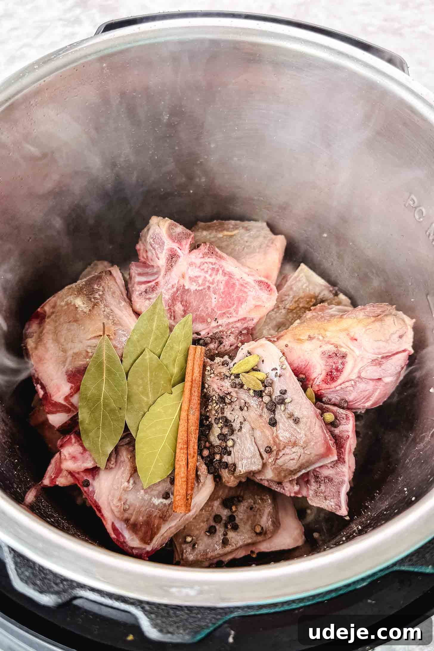 Mansaf: Jordan's Tangy Lamb Masterpiece 5 Lightly browned lamb shoulder in a steel pot with bay leaves, a cinnamon stick, black peppercorns and whole cardamom pods.