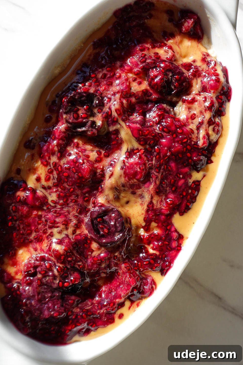 Dreamy Peanut Butter and Jelly Overnight Oats 2 Delicious Peanut Butter & Jelly Overnight Oats topped with creamy peanut butter and fresh chia jam swirls, ready for breakfast.