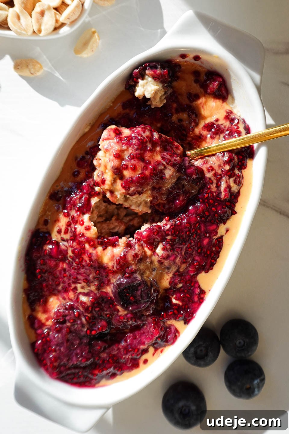 Dreamy Peanut Butter and Jelly Overnight Oats 6 A spoonful of creamy Peanut Butter & Jelly Overnight Oats showing the perfect texture and delightful layers.