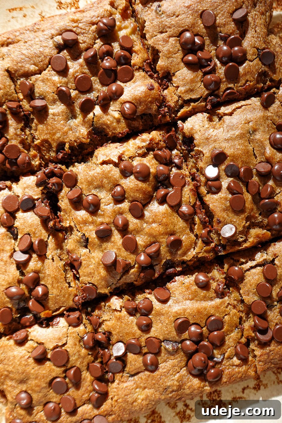 Vegan Gluten Free Chocolate Chip Banana Dream Bars 5 Vegan and gluten-free chocolate chip banana bars sliced into perfect squares on a rustic wooden board.