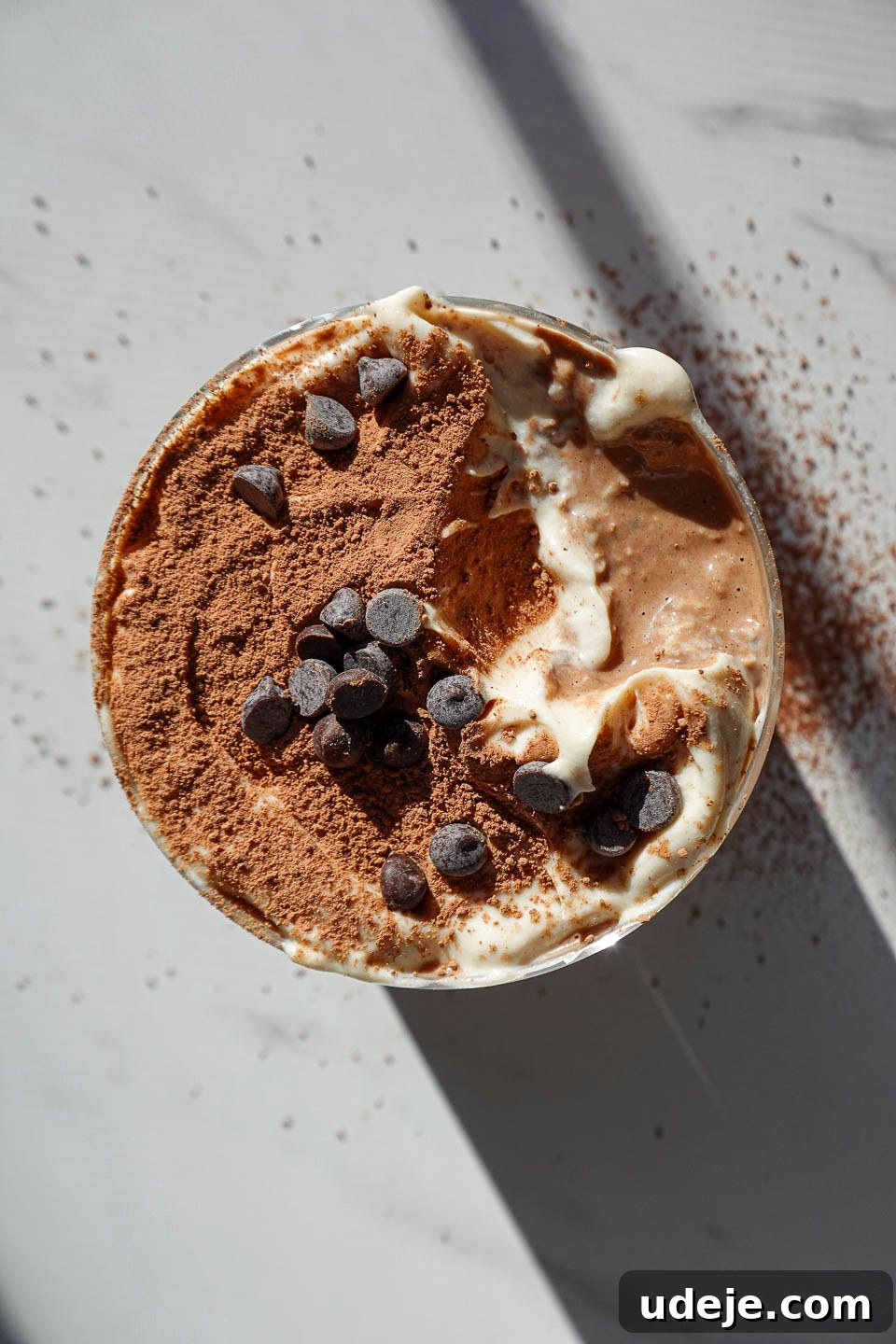 Espresso Dream Oats 2 Overhead shot of tiramisu overnight oats topped with yogurt, cocoa powder, and mini chocolate chips
