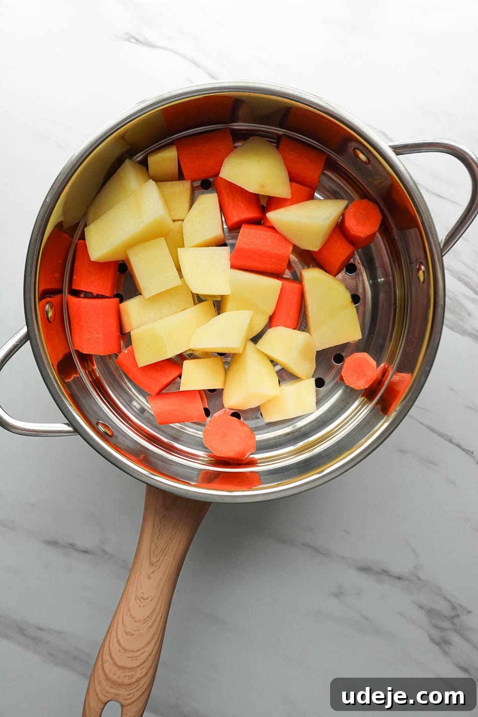 Golden Vegan Cheese Sauce Potato And Carrot Infusion 6 Chopped potatoes and carrots steaming in a steamer basket over boiling water