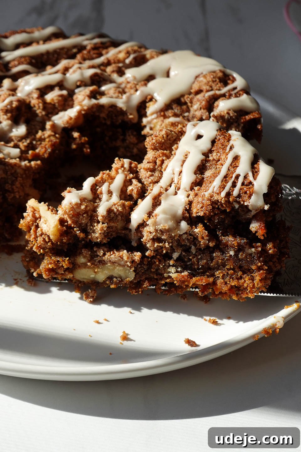 Decadent Spiced Carrot Coffee Cake Vegan Gluten Free 2 Close-up of vegan carrot cake coffee cake with walnut crumble and icing, perfect for spring baking.