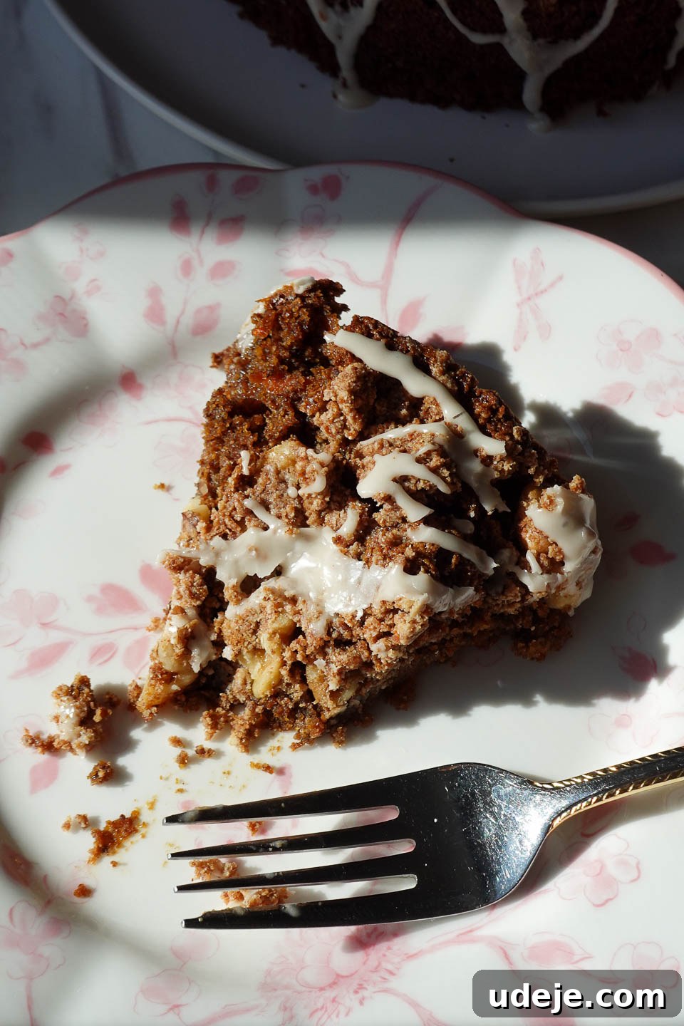 Decadent Spiced Carrot Coffee Cake Vegan Gluten Free 11 A fork cutting into a soft and moist slice of vegan carrot cake coffee cake, highlighting its delicate texture.