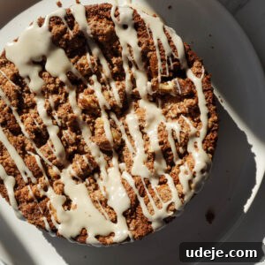 Drizzling dairy-free icing over baked carrot cake coffee cake