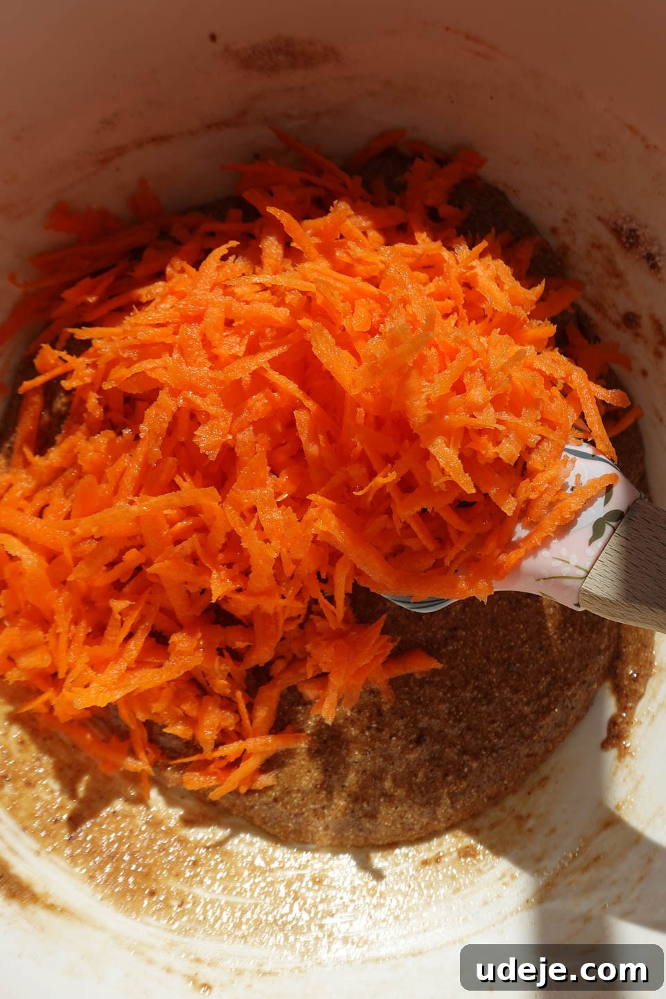 Decadent Spiced Carrot Coffee Cake Vegan Gluten Free 7 Freshly grated carrots being folded into the carrot cake batter.