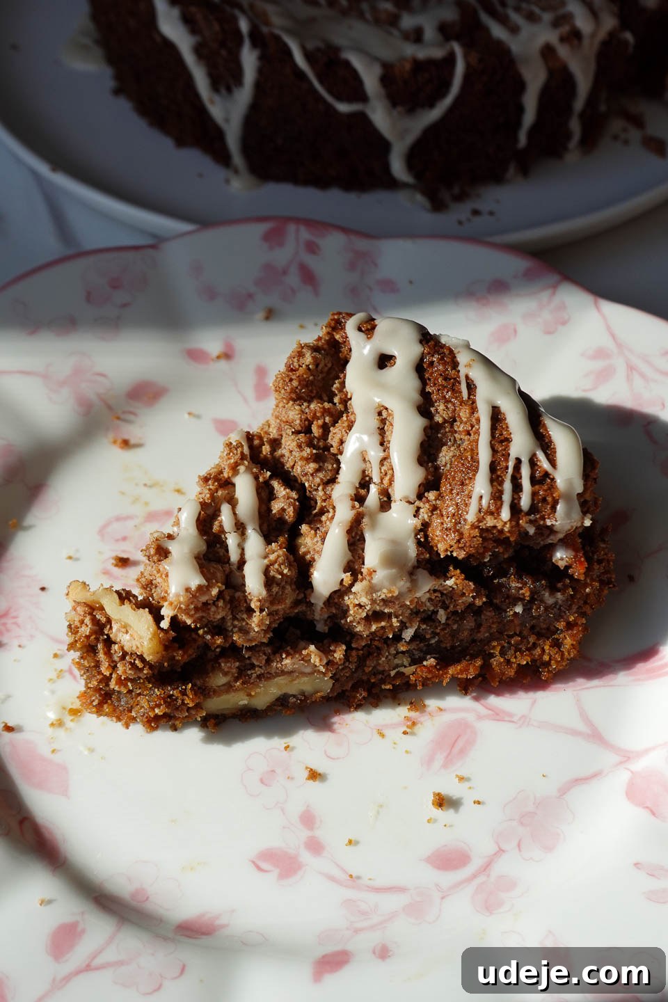 Decadent Spiced Carrot Coffee Cake Vegan Gluten Free 10 A close-up of a slice of vegan carrot cake coffee cake, showcasing its moist interior and crunchy walnut crumble topping.