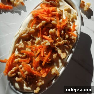Healthy carrot cake overnight oats with grated carrots, cinnamon, nutmeg, vegan yogurt, and walnuts