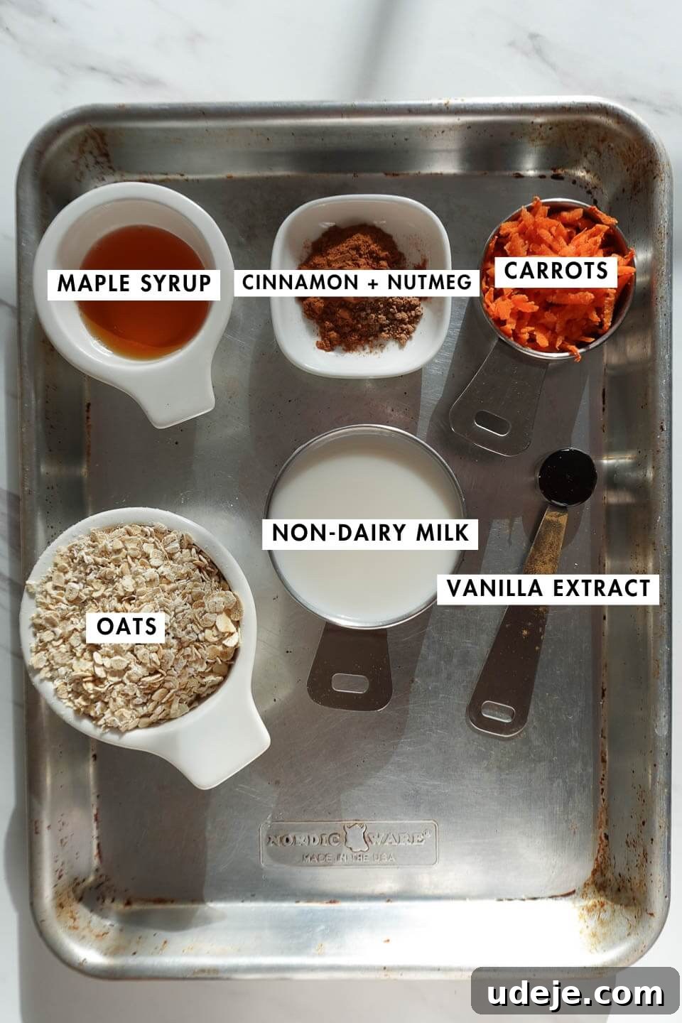 Overnight Carrot Cake Indulgence 5 Carrot cake overnight oats ingredients including oats, grated carrots, non-dairy milk, maple syrup, and spices