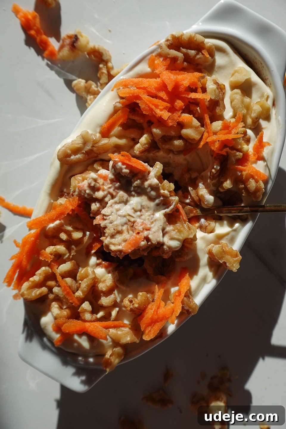 Overnight Carrot Cake Indulgence 9 Close up of carrot cake overnight oats with creamy yogurt, walnuts, and cinnamon