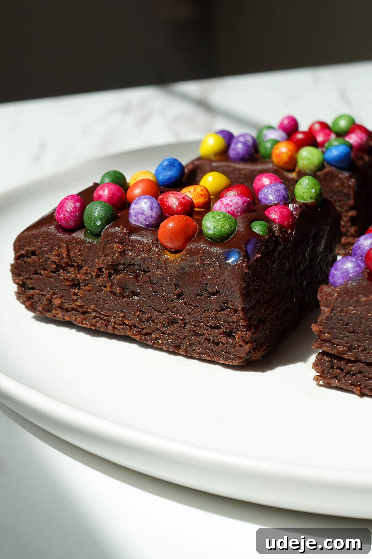No-Bake Vegan Gluten-Free Cosmic Brownies (Small Batch) 11 Side view of no bake cosmic brownie showing it's thick, fudgy, and rich texture.