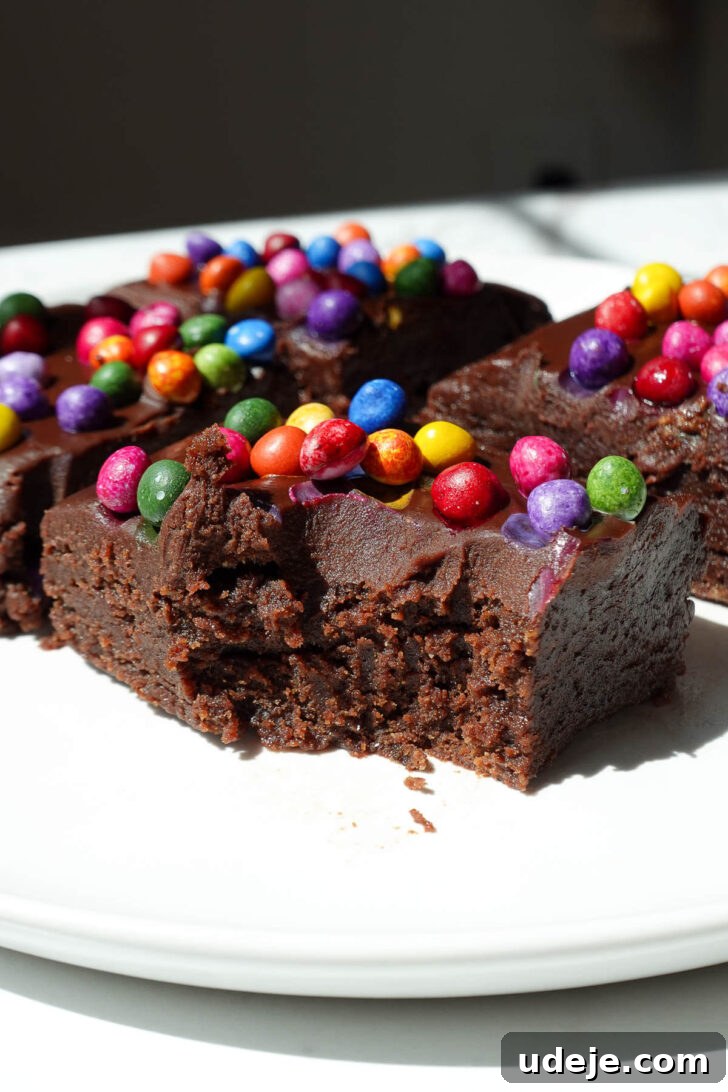 No-Bake Vegan Gluten-Free Cosmic Brownies (Small Batch) 13 No bake cosmic brownie with a bite taken out, showing it's fudgy texture.